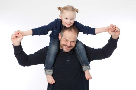 papa mit tochter auf der schulter im studio